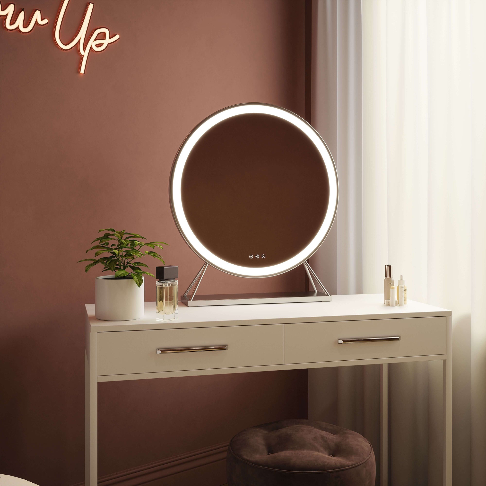Luxurious Isla Round Hollywood Mirror with silver frame and LED lighting on a vanity table, 60x63cm.