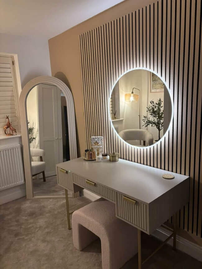 Ava Round Wall Mounted Mirror 80cm above a stylish vanity in a modern bedroom with ambient backlighting.