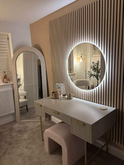 Ava Round Wall Mounted Mirror 80cm above a stylish vanity in a modern bedroom with ambient backlighting.