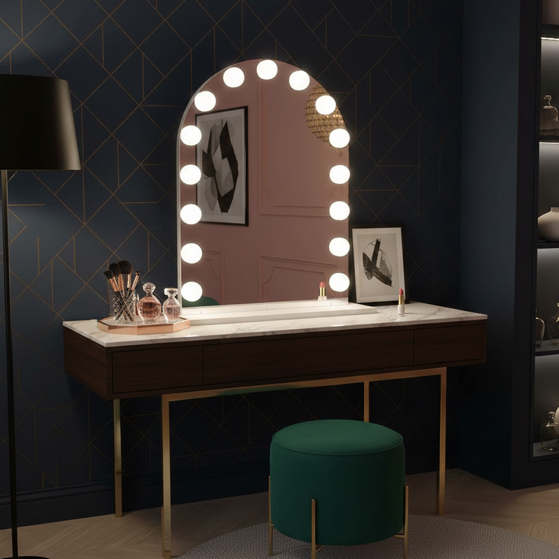 Makeup vanity with a mirror with lights on a dark wall.