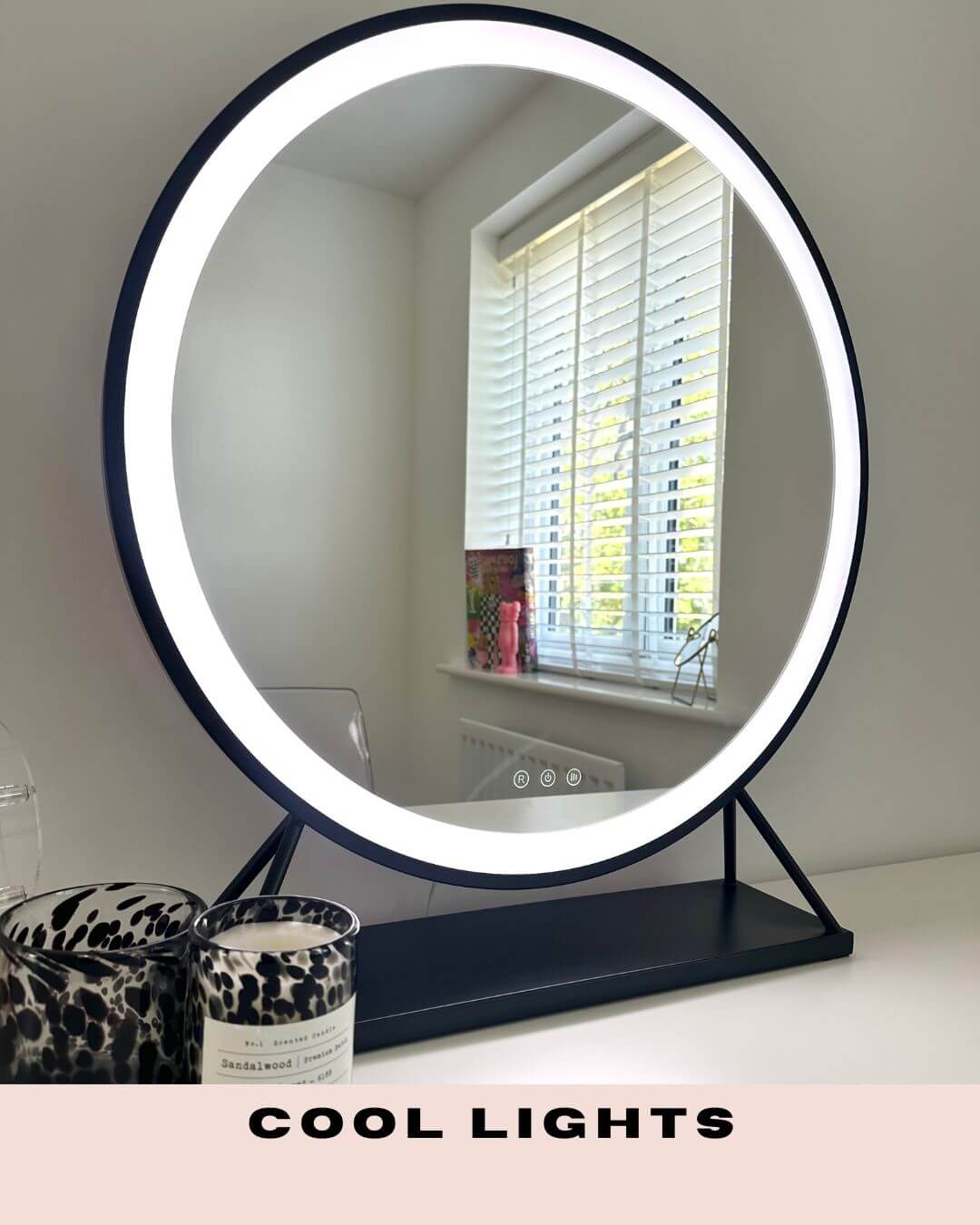 Grace Round Hollywood Mirror Black 60x63cm with LED lights displaying cool light setting on a vanity table.