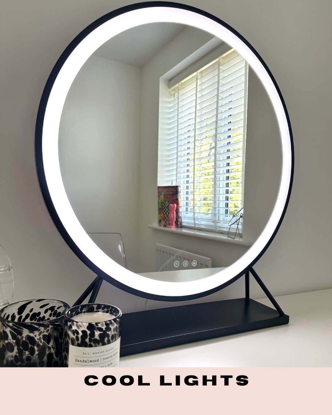 Grace Round Hollywood Mirror Black 60x63cm with LED lights displaying cool light setting on a vanity table.