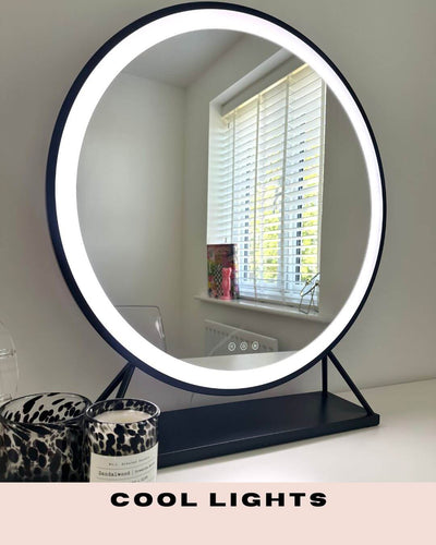 Grace Round Hollywood Mirror Black 60x63cm with LED lights displaying cool light setting on a vanity table.