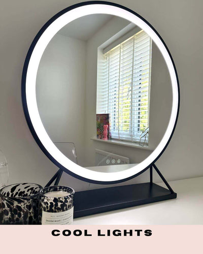 Grace Round Hollywood Mirror Black 60x63cm with LED lights displaying cool light setting on a vanity table.