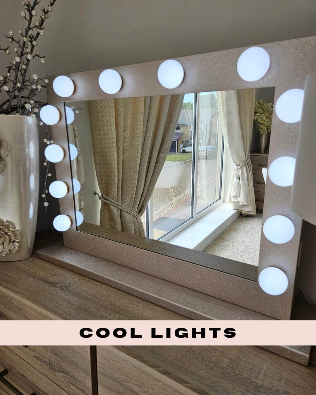 Jolie Gold Hollywood Mirror 80 x 60cm with cool lights setup on a wooden dresser near a window.