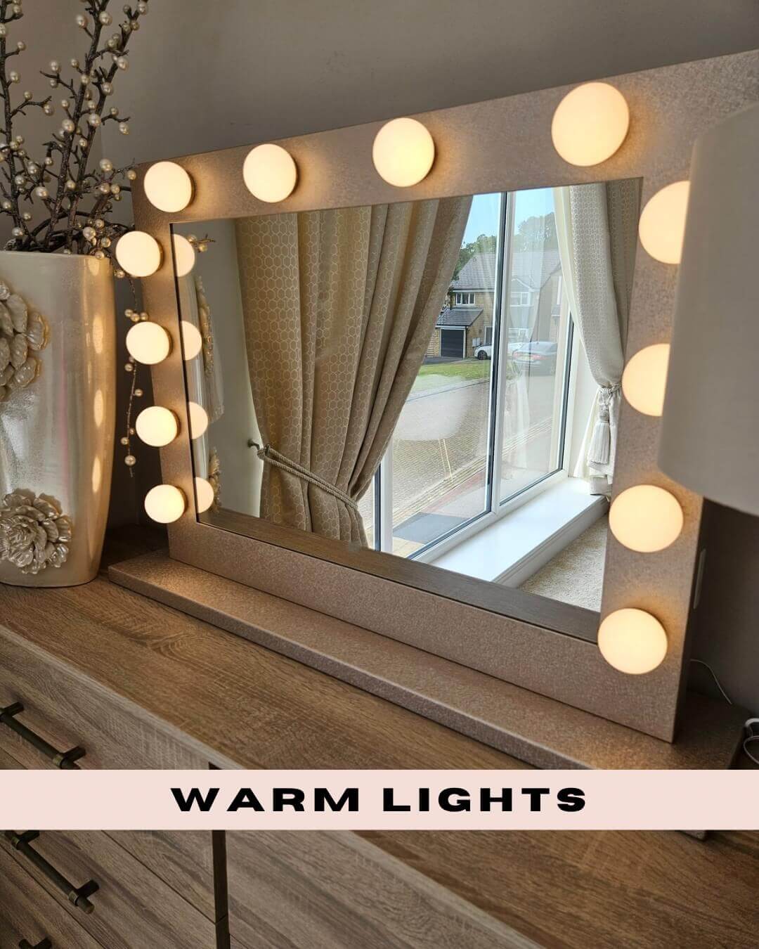 Jolie Gold Hollywood Mirror 80 x 60cm with warm lights on a wooden dressing table.