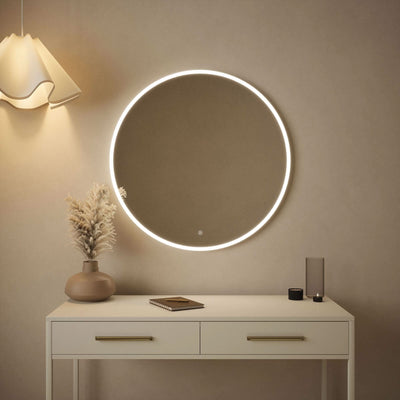 Luna 80cm round wall-mounted backlit mirror with soft glow in bedroom setting, featuring sleek touch control panel.