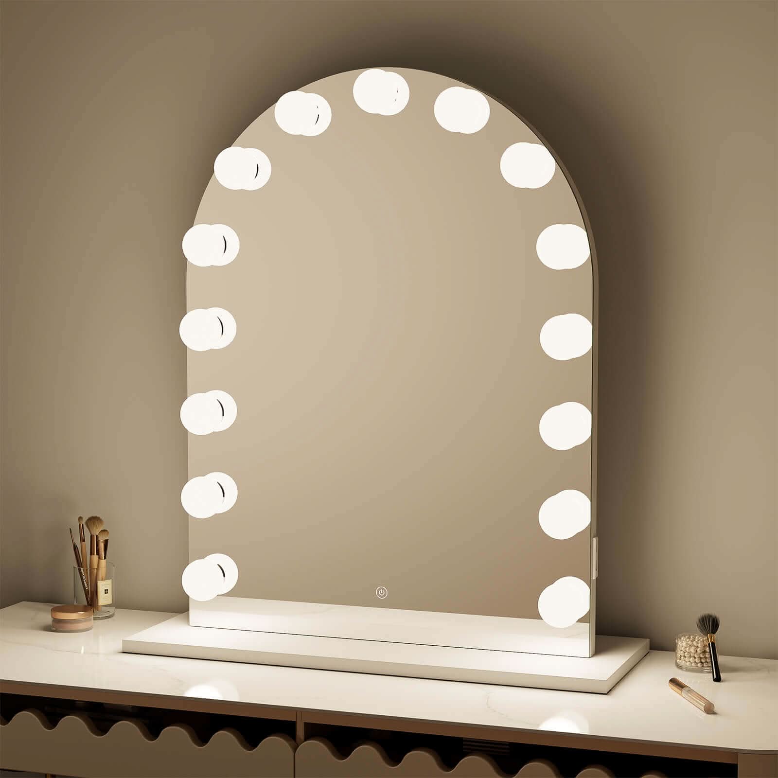 Charlize Arch Hollywood Mirror with LED bulbs on tabletop, featuring a soft arch design and built-in power, ideal for any vanity.
