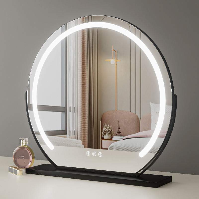 Round LED vanity mirror with a modern interior reflection on a gray wall.