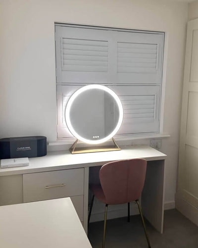 Anne Round Hollywood Mirror Gold 60x63cm on a vanity table with customizable LED lighting for elegance and sophistication.