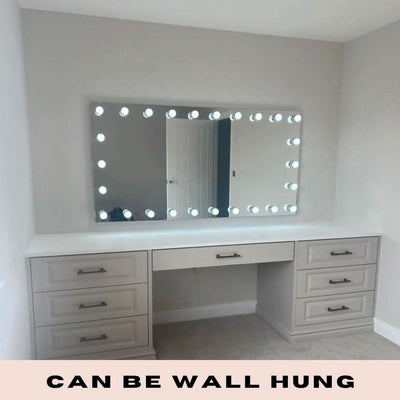 Hollywood mirror with LED bulbs, wall mounted above a white vanity table, provides perfect lighting for makeup, text: 'Can Be Wall Hung'
