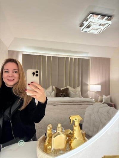 Ava Round Wall Mounted Mirror 80cm reflecting a modern bedroom with stylish decor and perfume bottles.