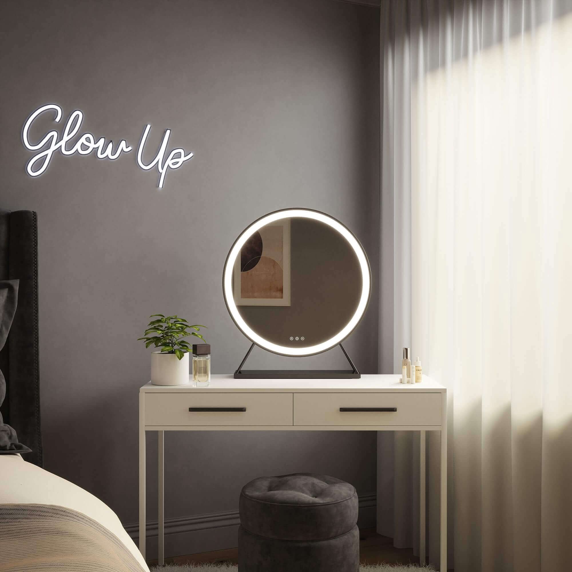 Grace Round Hollywood Mirror Black 60x63cm on white dressing table with plant, featuring customisable LED lighting in elegant room.
