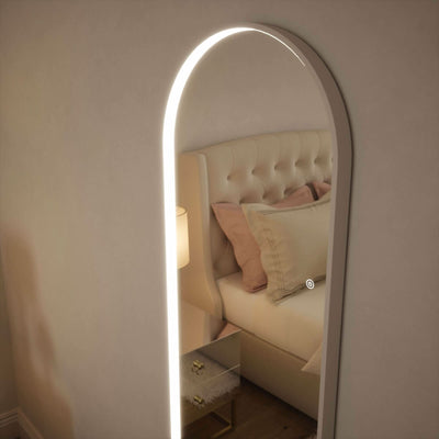 Sophia Full Length Arch Mirror with LED lighting and white frame, reflecting a cozy bedroom with a luxurious bed and soft decor.