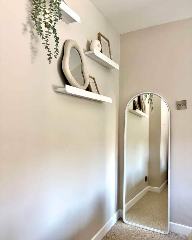 Sophia Full Length Arch Mirror White Frame reflecting a styled modern room with shelves and decor.
