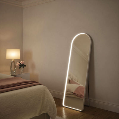 Sophia Full Length Arch Mirror White Frame in bedroom with LED glow, showcasing touch-activated lighting features for style and elegance.