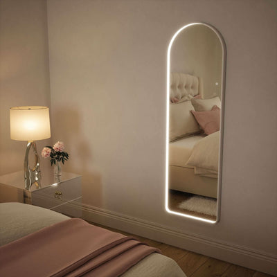 Sophia Full Length Arch Mirror White Frame with LED lights in bedroom setting, featuring elegant, modern design and versatile lighting options.