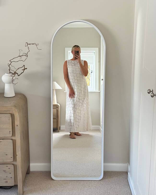 Sophia Full Length Arch Mirror White Frame with LED lighting displaying a woman in a white dress in a stylish room setting.