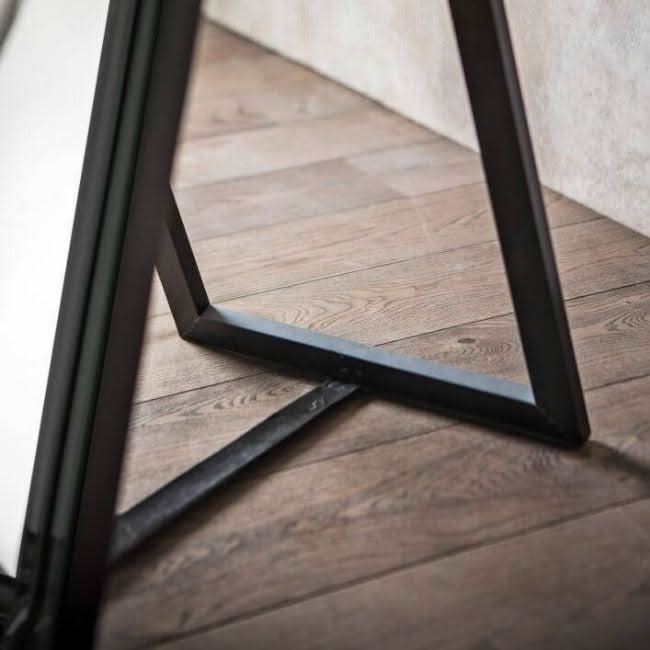 Angled Luna Mirror-Cheval Black kickstand detail on wooden floor, elegant design