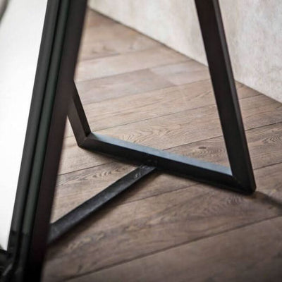 Angled Luna Mirror-Cheval Black kickstand detail on wooden floor, elegant design