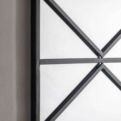 Close-up of Art Deco window mirror with black metal frame, featuring industrial design elements for living room or hallway.