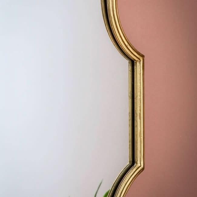 Cassie Gold Wall Mirror with ornate frame, perfect for console or dressing table, adding a glamorous touch to room decor and practical use.