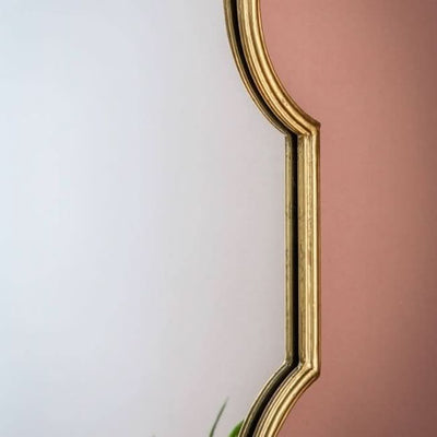 Cassie Gold Wall Mirror with ornate frame, perfect for console or dressing table, adding a glamorous touch to room decor and practical use.