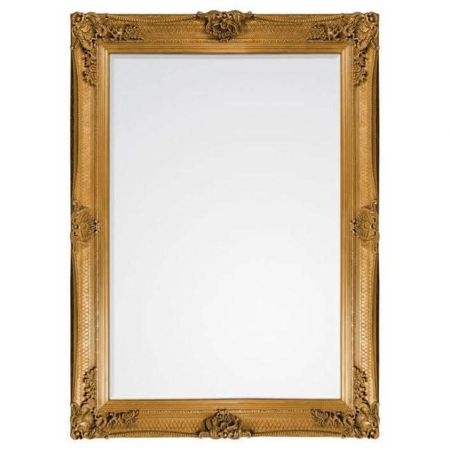 Baroque-style handcrafted wood framed mirror with gold leaf finish, hanging vertically on a wall.