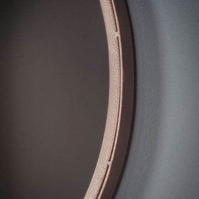 Close-up of large Broadway round mirror with metal frame and hanging strap, adding rustic flair to walls, dimensions: 510x915 mm.