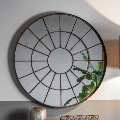 Large round industrial chic window mirror with bronzed metal frame and textured glass, perfect for enhancing rustic home decor.