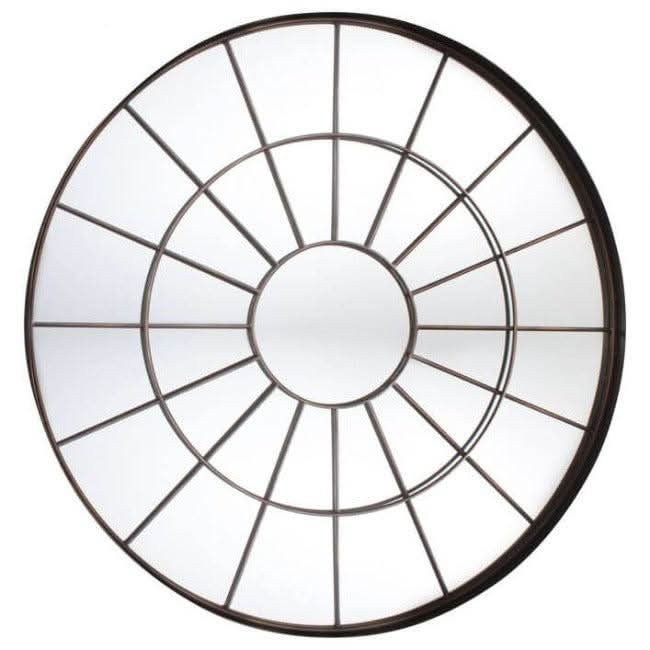 Large round chic industrial window mirror with bronzed metal frame, hanging on a wall above a console table, adding rustic charm to the room.