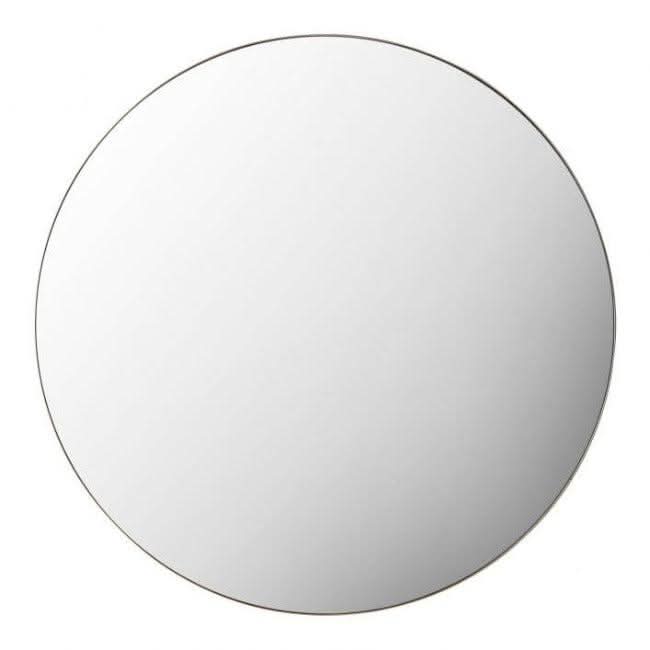 Scandi large round mirror with champagne metal frame, 80cm, wall hanging on green wall, reflecting room interior.