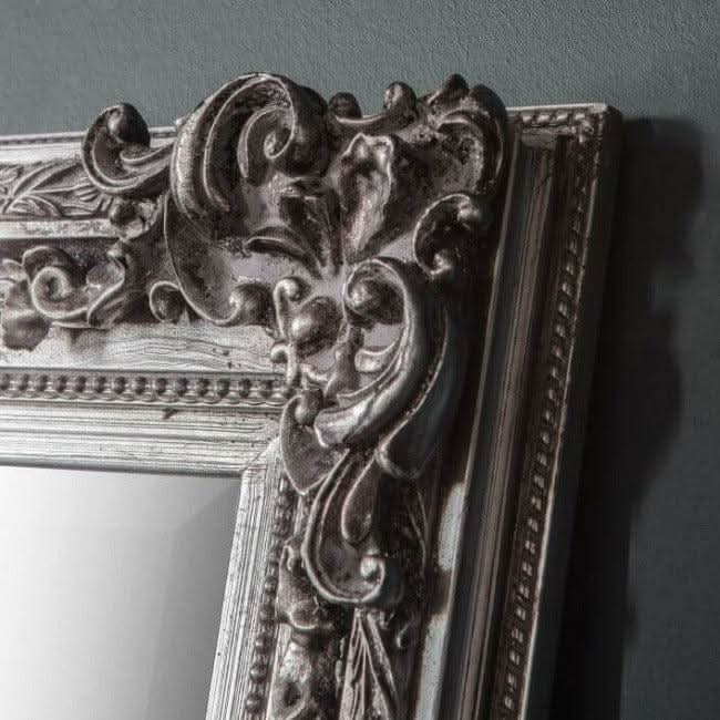 Close-up of stone gray small baroque-style mirror frame with intricate detailing, classic wall decor for a sophisticated look.