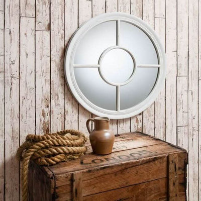 Vintage white round mirror with porthole design, light crackle texture, on rustic wooden wall. Ideal for nautical-themed decor.