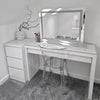 A modern vanity setup with the hollywood mirrors Hollywood Crystal Pro Mirror 80x60cm, featuring dimmable lights, a clear acrylic chair, small white drawers, minimalist decor with a vase and white piece, plus grey carpet and white walls.