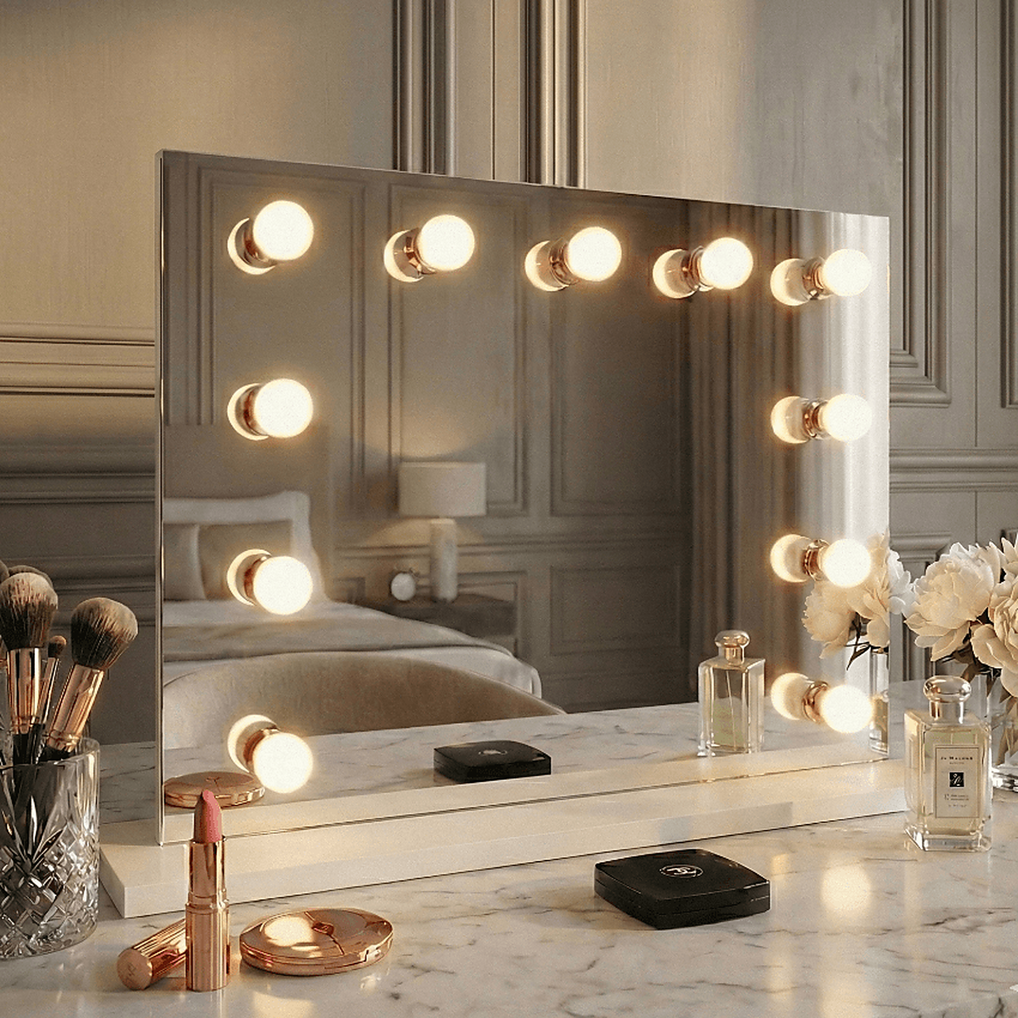 Hepburn Hollywood Mirror 80x60cm with LED bulbs on a marble dressing table, showcasing beauty products and flowers.