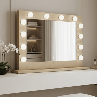 Modern vanity with illuminated mirror and stool in a neutral-colored room.