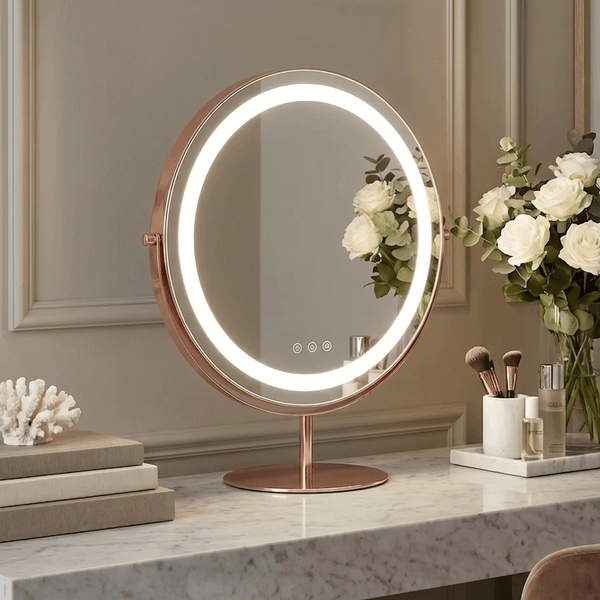 Celeste LED Vanity Mirror — Rose Gold on a marble vanity with flowers and makeup tools.