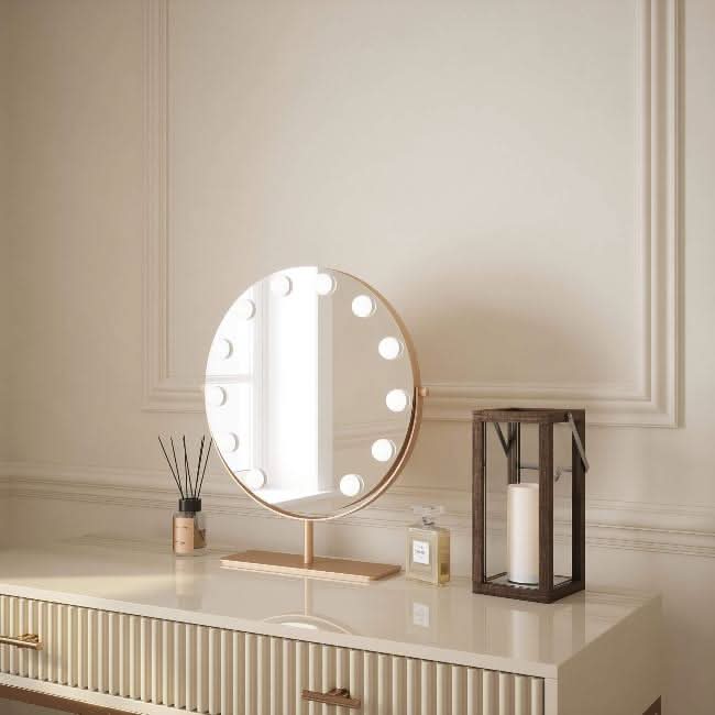 Hawn Gold Round Hollywood Mirror 42x48cm on a vanity, featuring versatile LED lighting for a touch of glamour in your home.