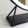 Modern black base of a round Hollywood mirror showcasing adjustable lighting features.