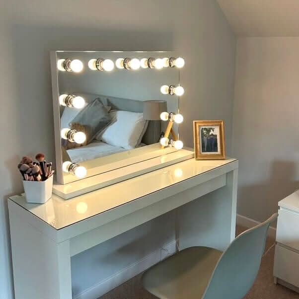 Hepburn Hollywood Mirror with LED tri bulbs on a modern vanity desk, featuring glamorous studio lighting for makeup and selfies.