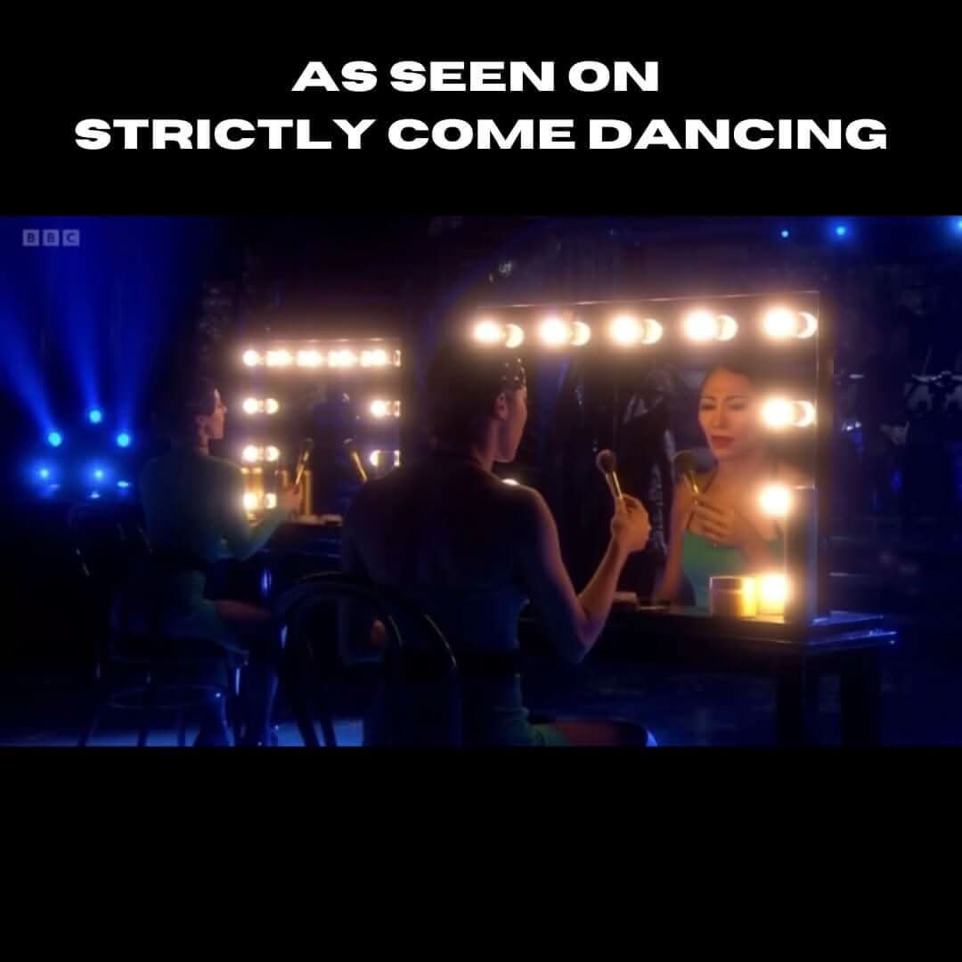 Person using Hepburn Hollywood Mirror with LED lights, as featured on a dance show, highlighting its studio-quality lighting.