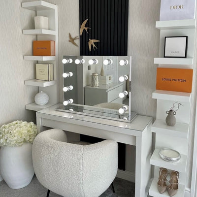 Houston Bluetooth Hollywood Mirror 80x60cm with LED lights on vanity desk in elegant room with shelves.