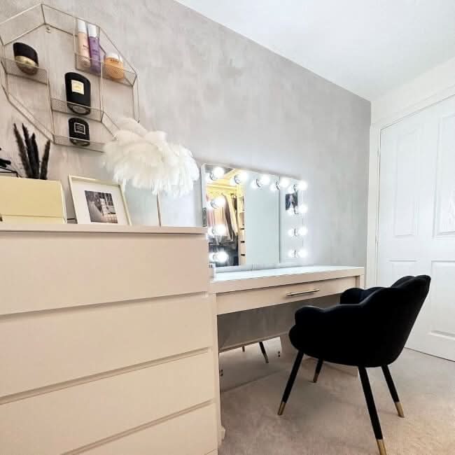 Elegant vanity setup with Houston Bluetooth Hollywood Mirror featuring LED lights and black chair, perfect for makeup application.