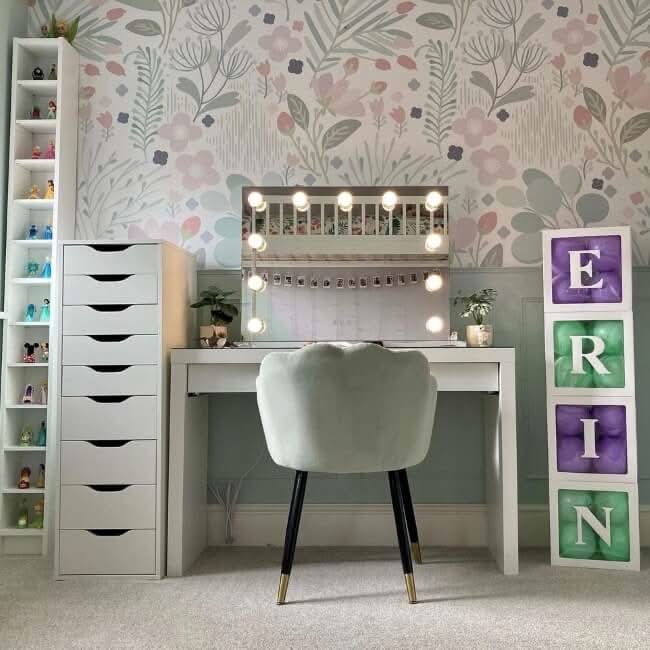 Houston Bluetooth Hollywood Mirror on a vanity desk with LED bulbs and Bluetooth speakers in a stylish bedroom setup.