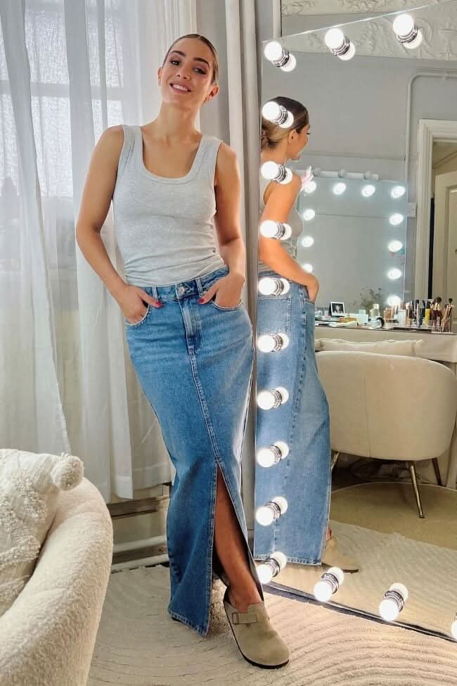 Woman standing by Keira Full Length Hollywood Mirror with lights in a stylish room.