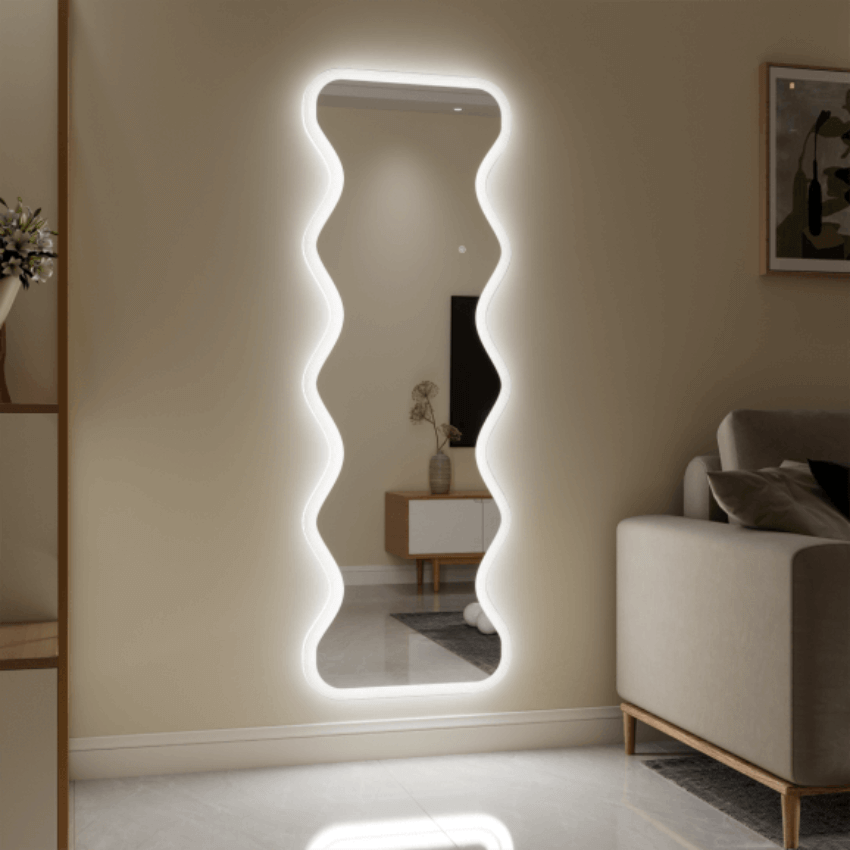 Wavy full-length mirror with illuminated edges in a modern living room, featuring elegant Italian design in a minimalist style.