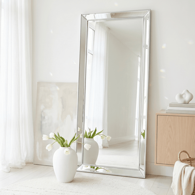 Large silver bevelled full length leaner mirror 178cm leaning against white wall in minimalist living room with natural light