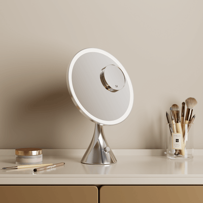 LumiGlam Pro Chrome Vanity Mirror on a counter with makeup brushes and cosmetics, showcasing elegant design and tri-light technology.