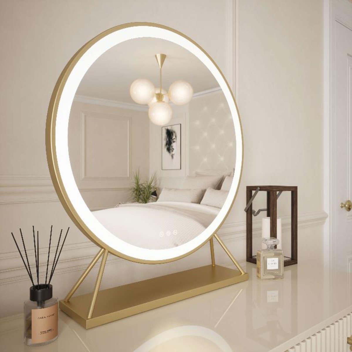 Anne Round Hollywood Mirror Gold 60x63cm with customizable lighting and touch sensor sits on a glossy dresing table desk, reflecting a modern bedroom. A candle and glass box are placed beside this illuminated mirror.